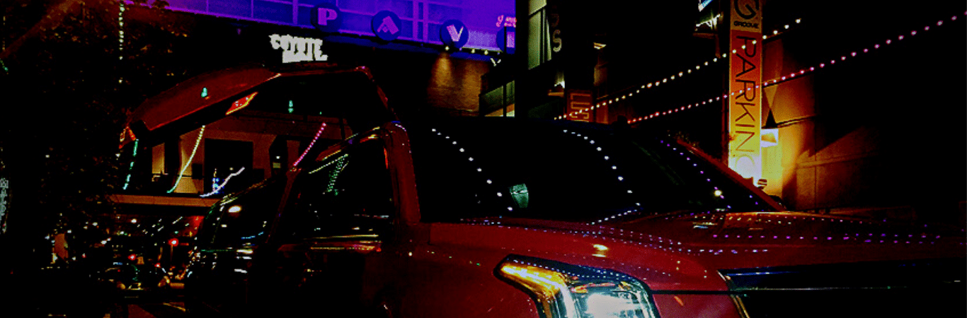 A night photo with a red limo