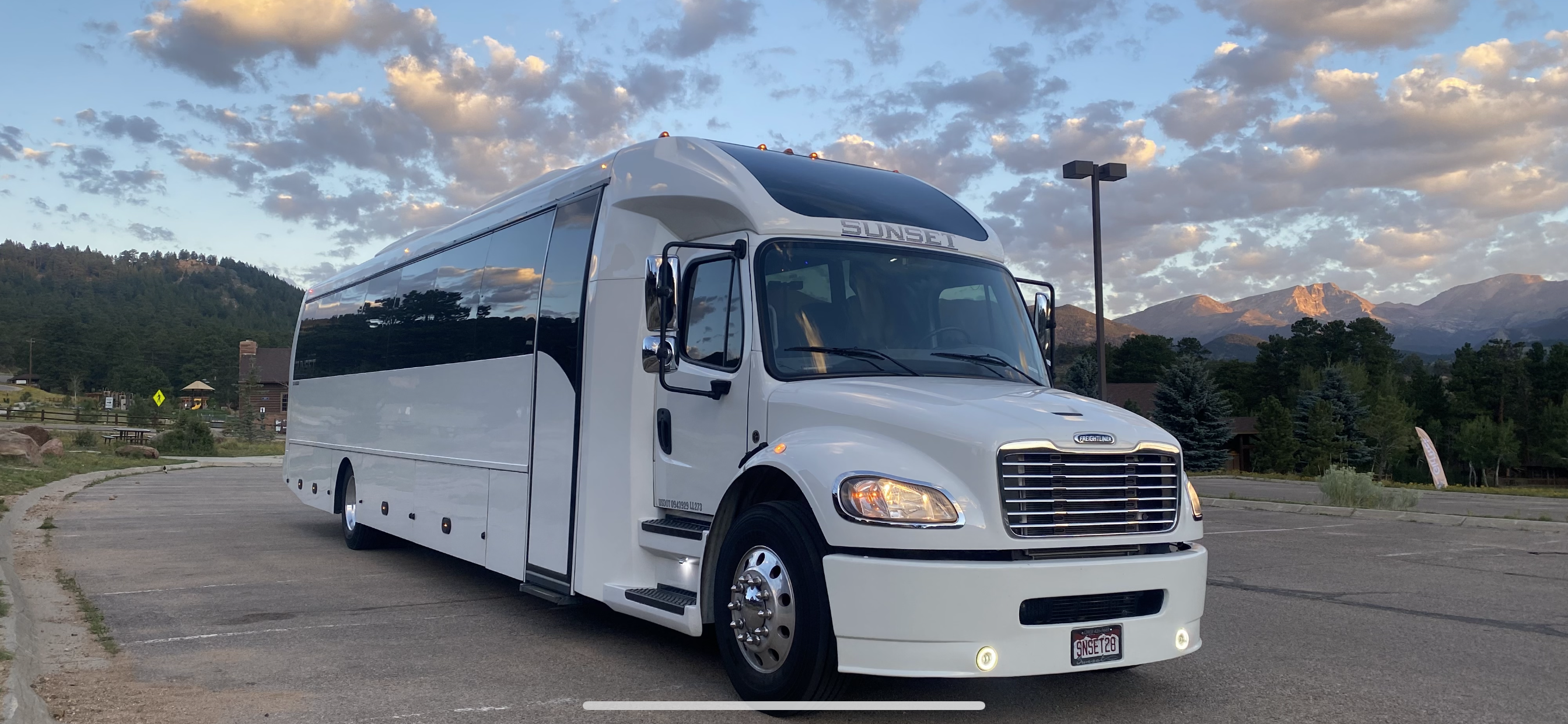 A white limo bus with dark windows