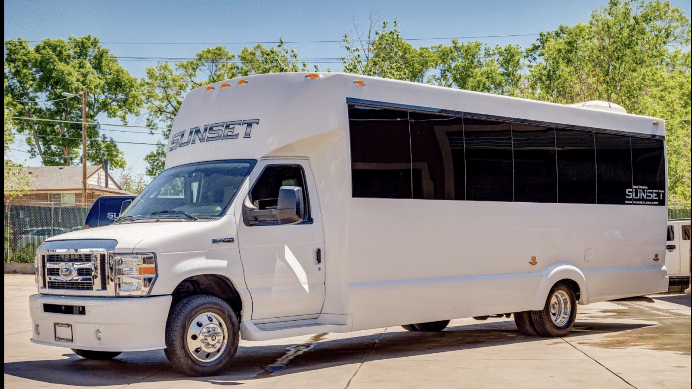 A white limo party bus with tinted windows