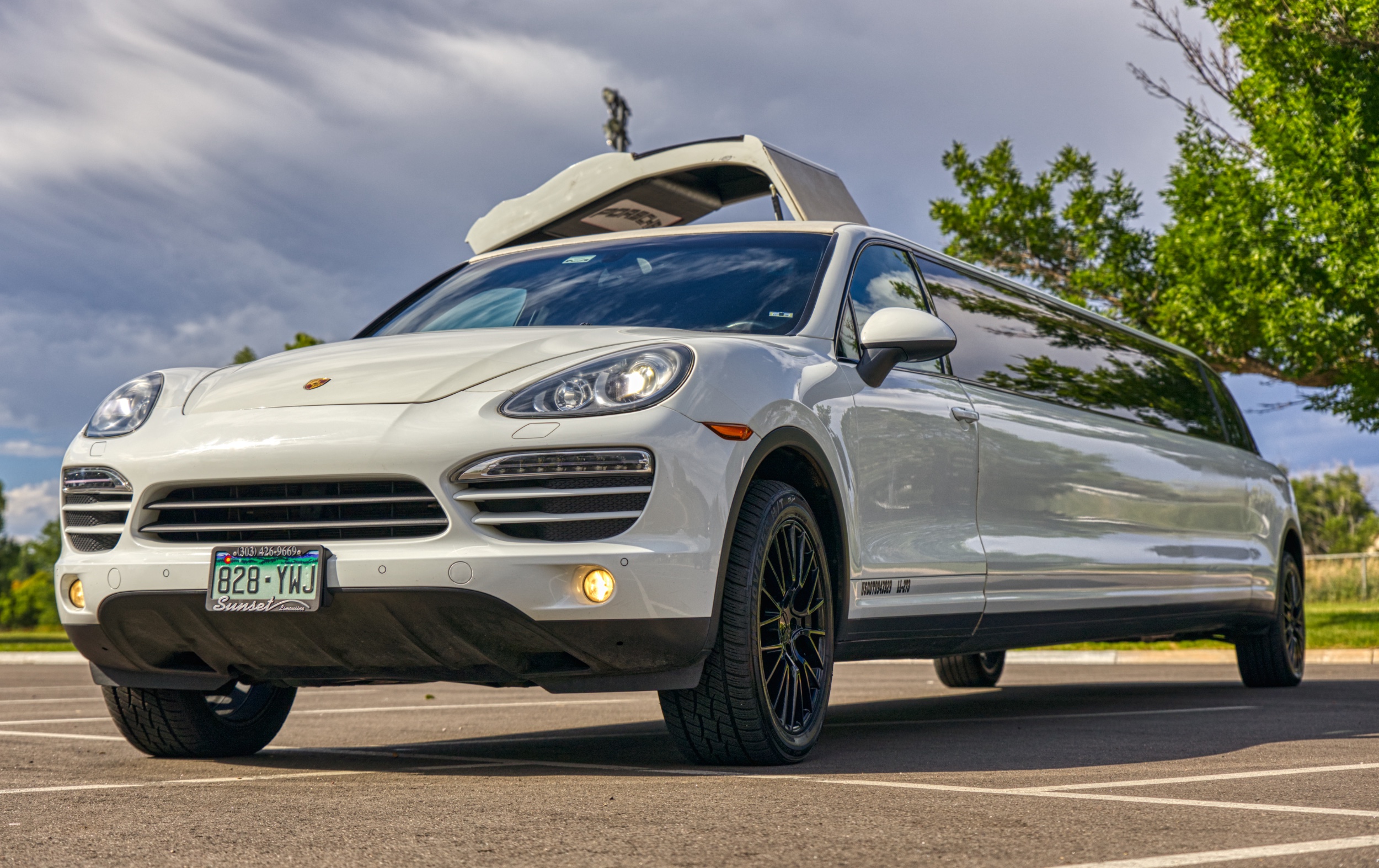 A white porsche cayenne with tinted windows