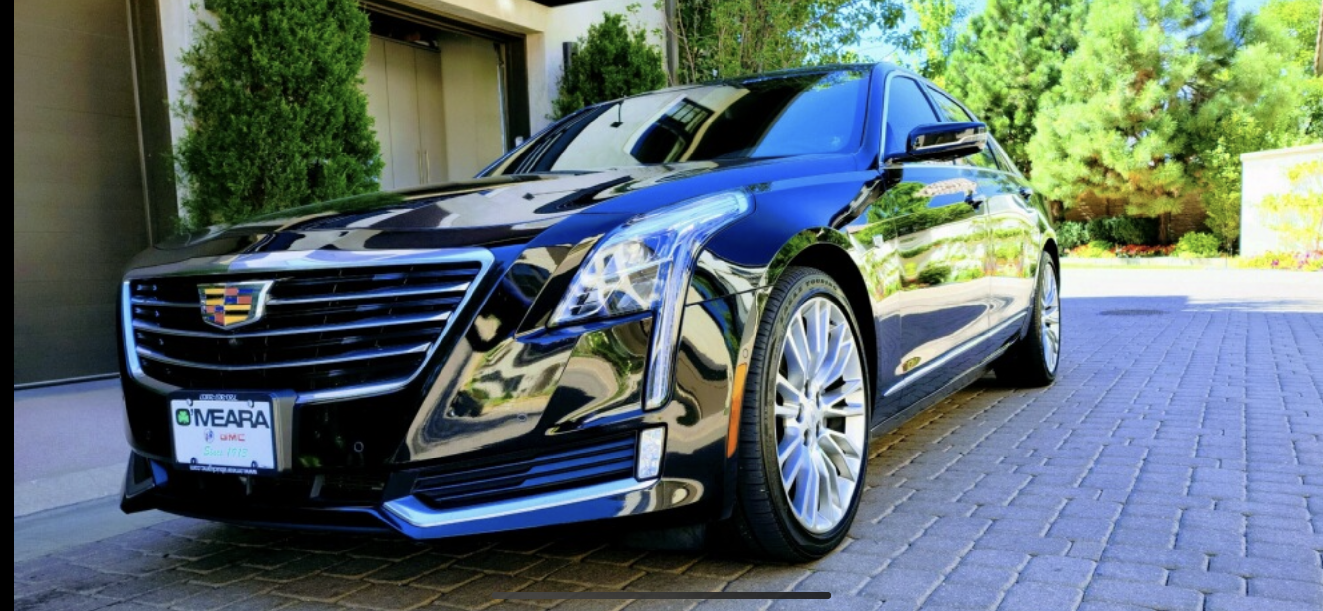 A black Cadillac CT6 with a reflective shine and beautiful wheels.